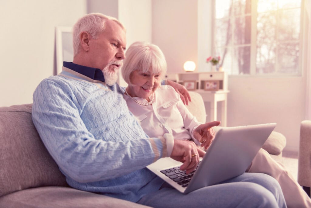 couple sitting together looking at computer