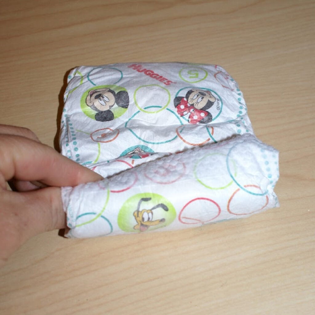 rolling up a diaper for a bouquet