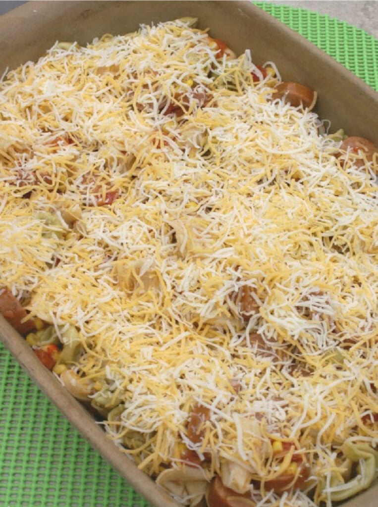 spicy sausage tortellini bake in a pan ready to bake