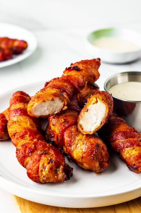 close up of partially eaten bacon wrapped chicken tenders