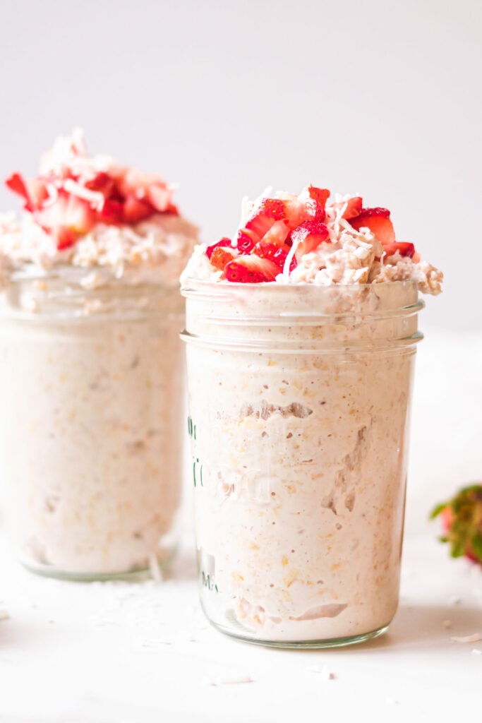 overnight oats with strawberry toppings in a mason jar