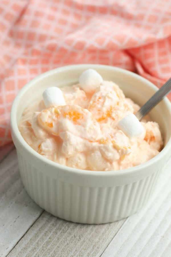 bowl of orange fluff with marshmallows on top