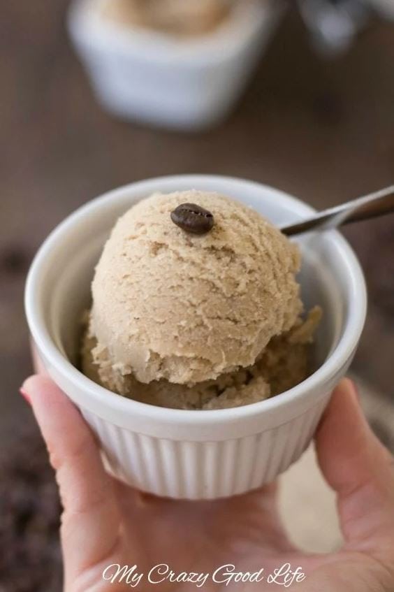 scoop of coffee ice cream in a bowl with a coffee bean on top