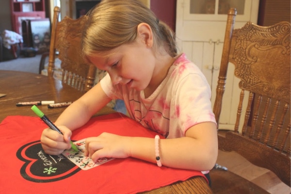 girl using a chalk of the town shirt