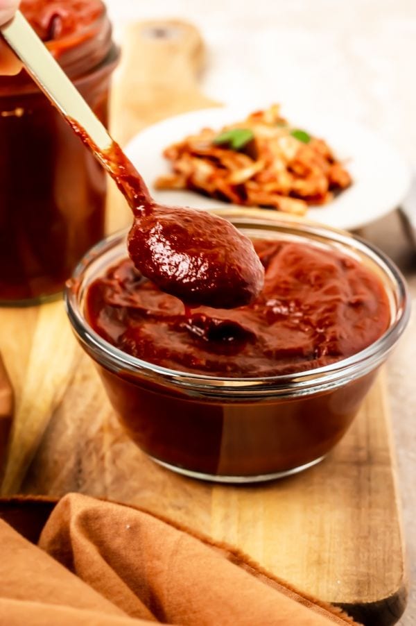 close up of a small glass bowl of bbq sauce