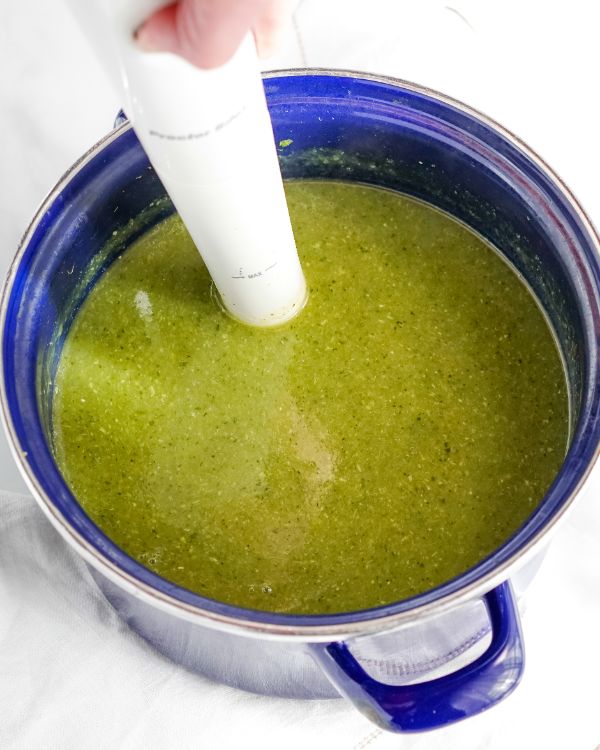 using an immersion blender to puree detox soup