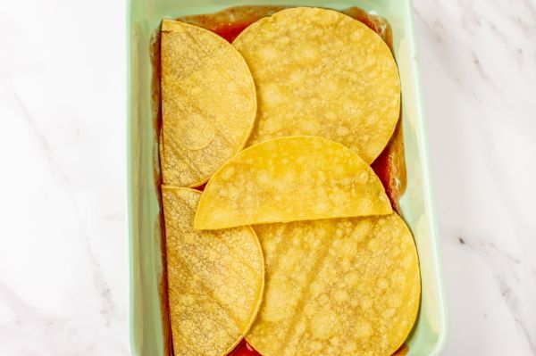 pan with layers of ingredients for enchiladas