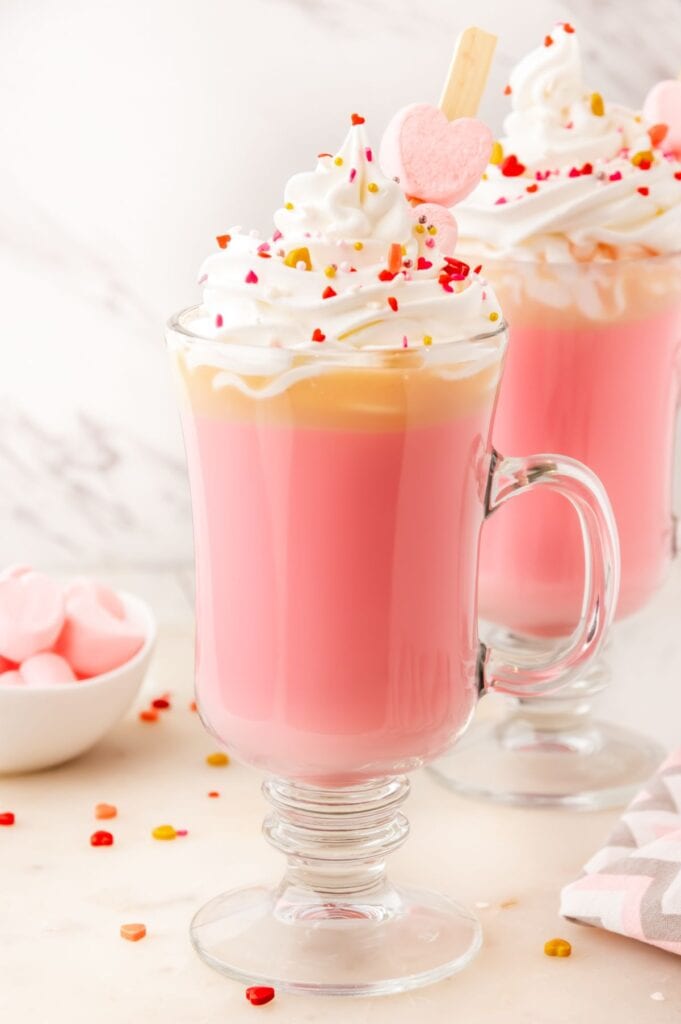 glass mug of cupid cocoa with sprinkles on top