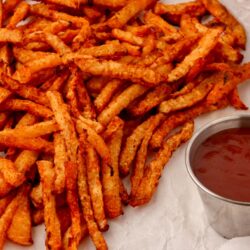 close up of air fried jicama fries with a side of ketchup