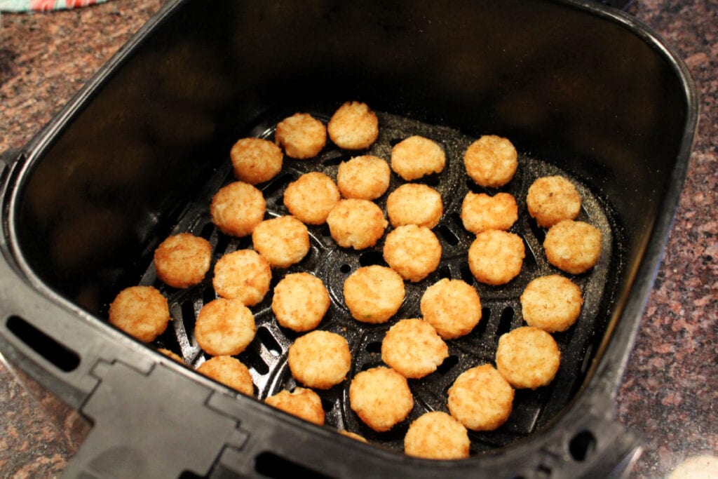 uncooked frozen crispy crowns in the air fryer basket ready to cook