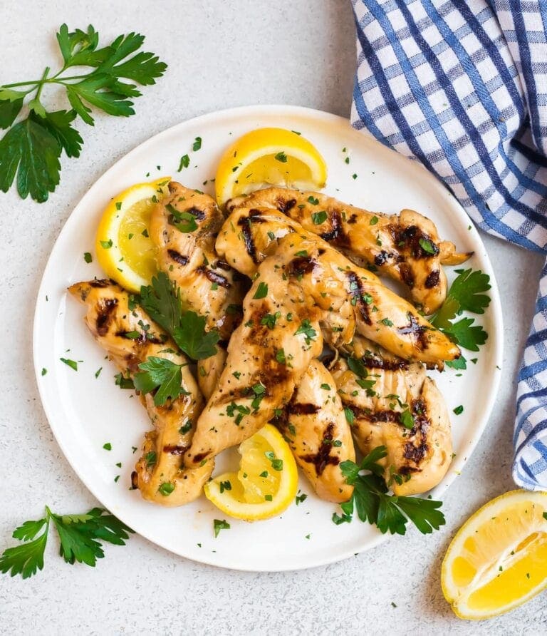 Juicy grilled tenders with garnish and lemons