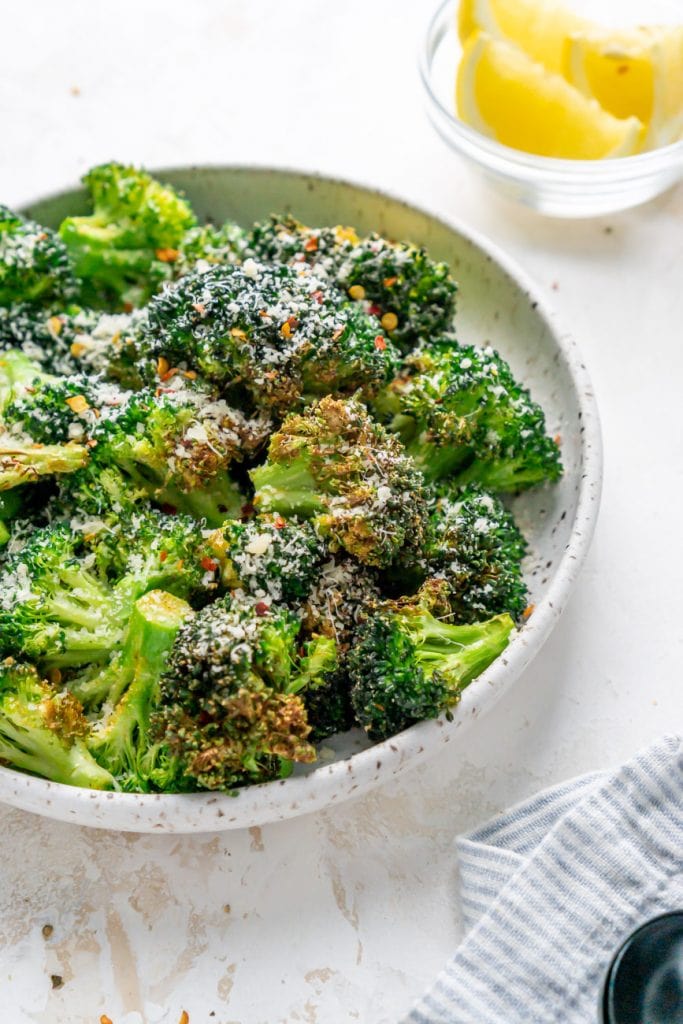 air fried broccoli on a plate with toppings