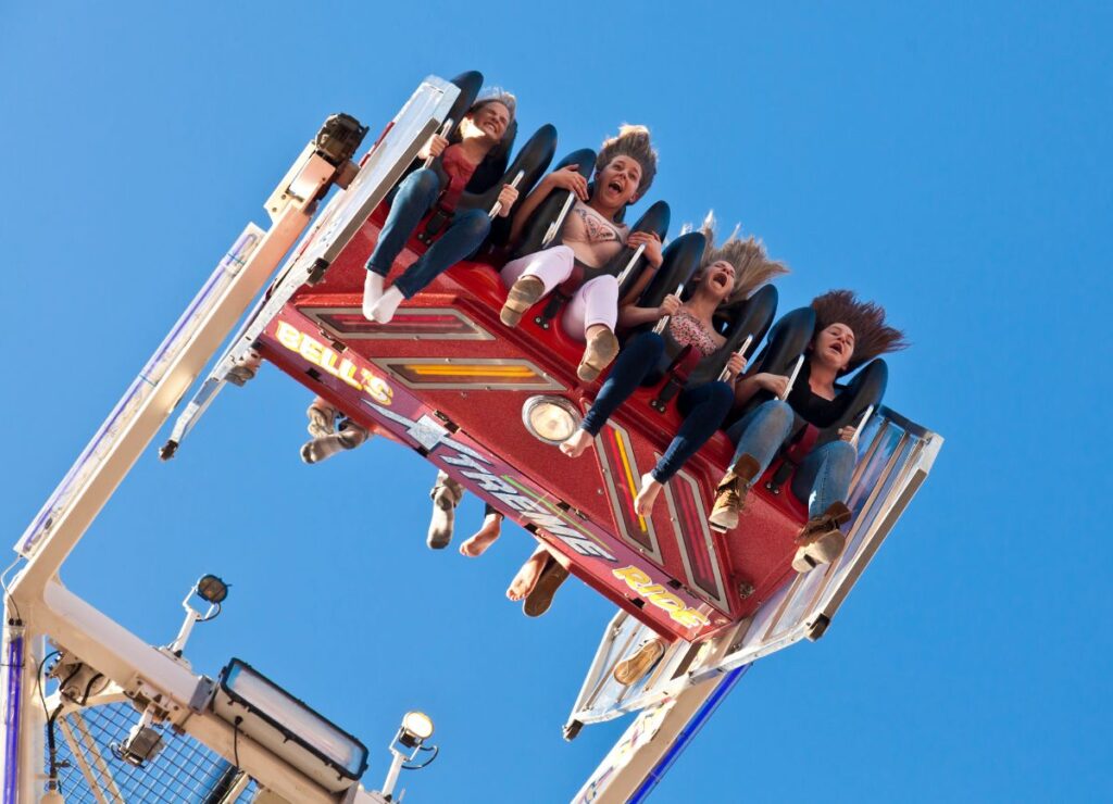 kids riding a scary ride at an amusement park
