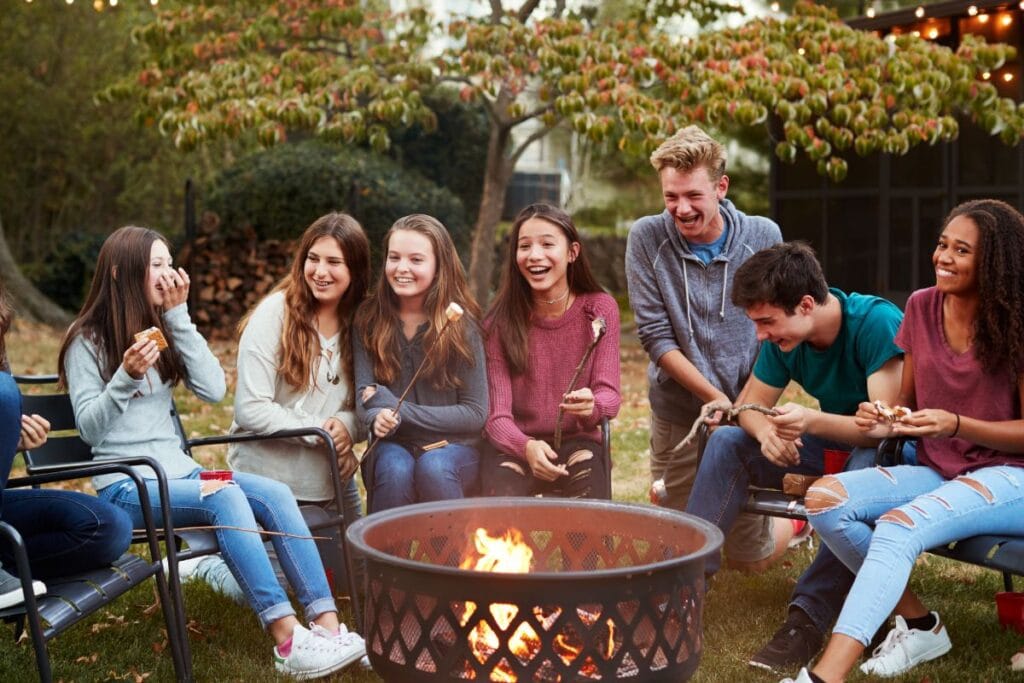 kids roasting marshmallows over a fire pit