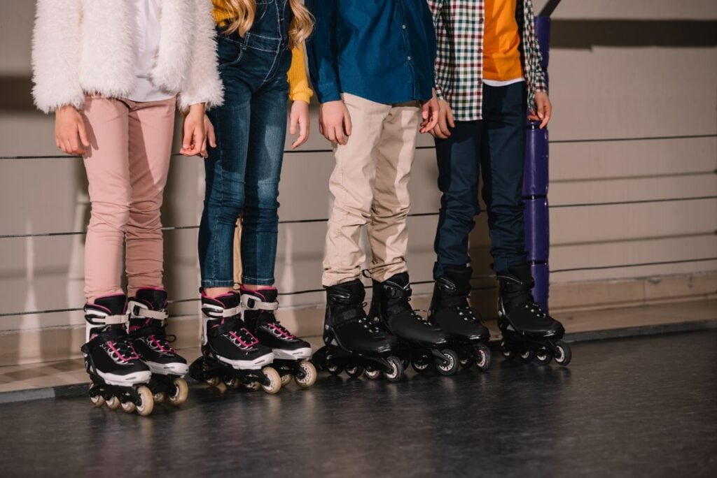four teens standing in skates