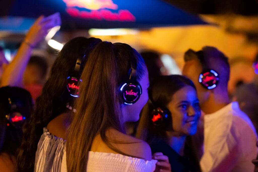 kids at a silent disco wearing headphones