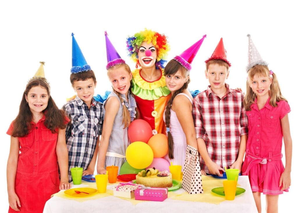 kids wearing birthday party hats standing with a clown