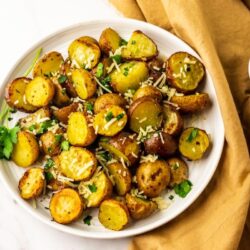 Italian Roasted Potatoes with a bowl of cheese on the side