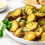 close up view of roasted potatoes with garnish