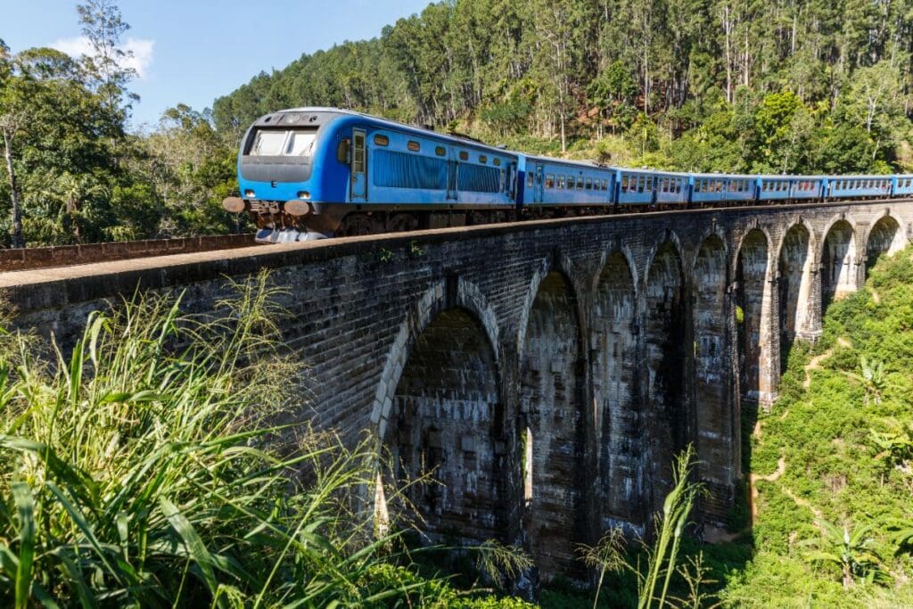 train going over a brick bridge