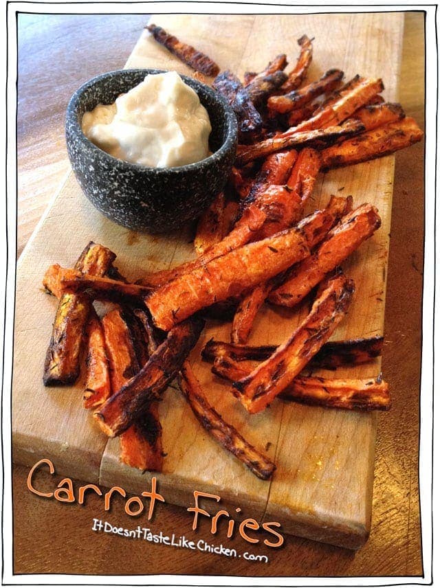carrot fries on a wooden board with a dip