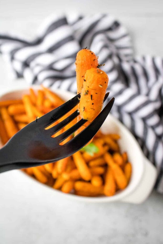 2 baby carrots on a fork