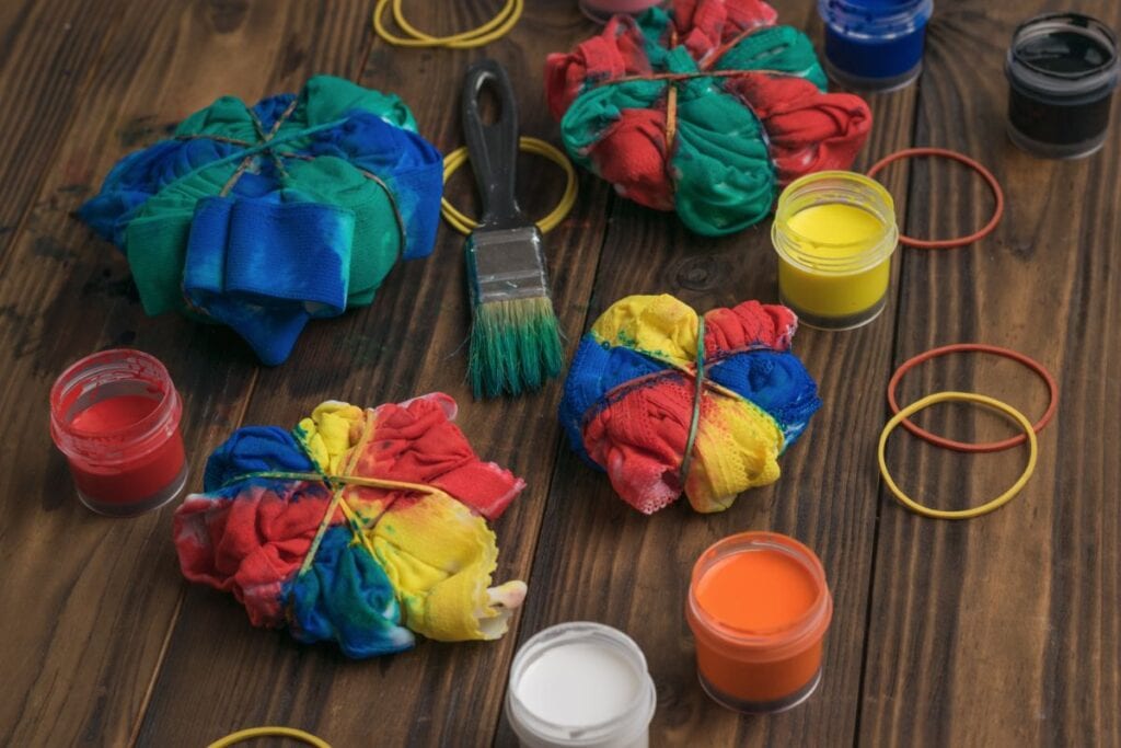 paint brush, elastic bands, tied up shirts, and lots of dye
