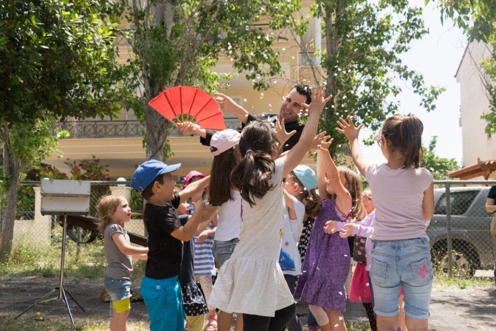kids surrounding a magician