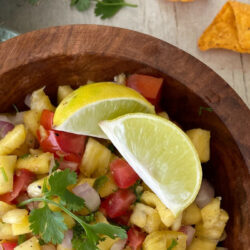 Salsa with lemon wedges and tortilla chips