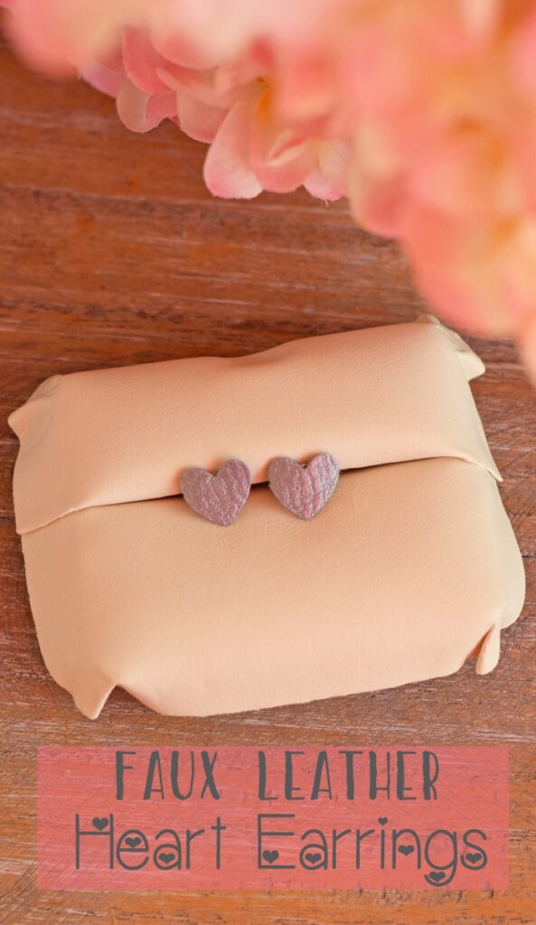 Heart leather earring on a cushion