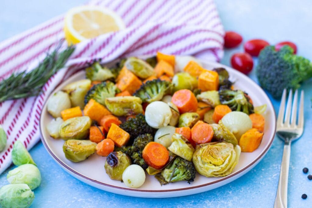 Roasted carrots, onions, broccoli, and brussels sprouts on a plate