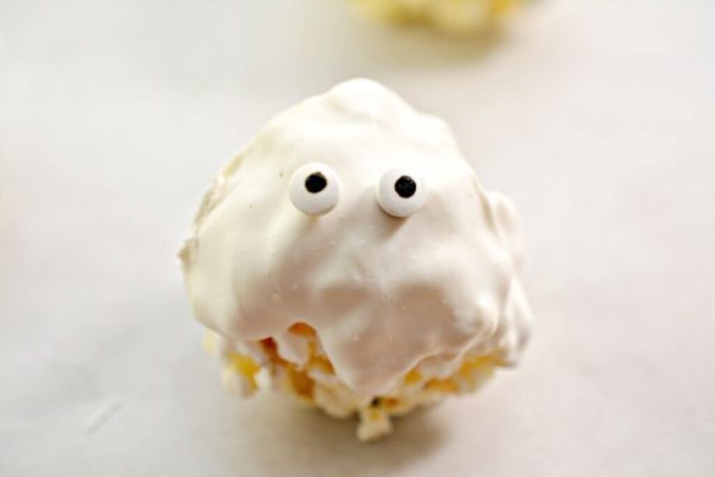 popcorn coated in white mixture with edible eyes