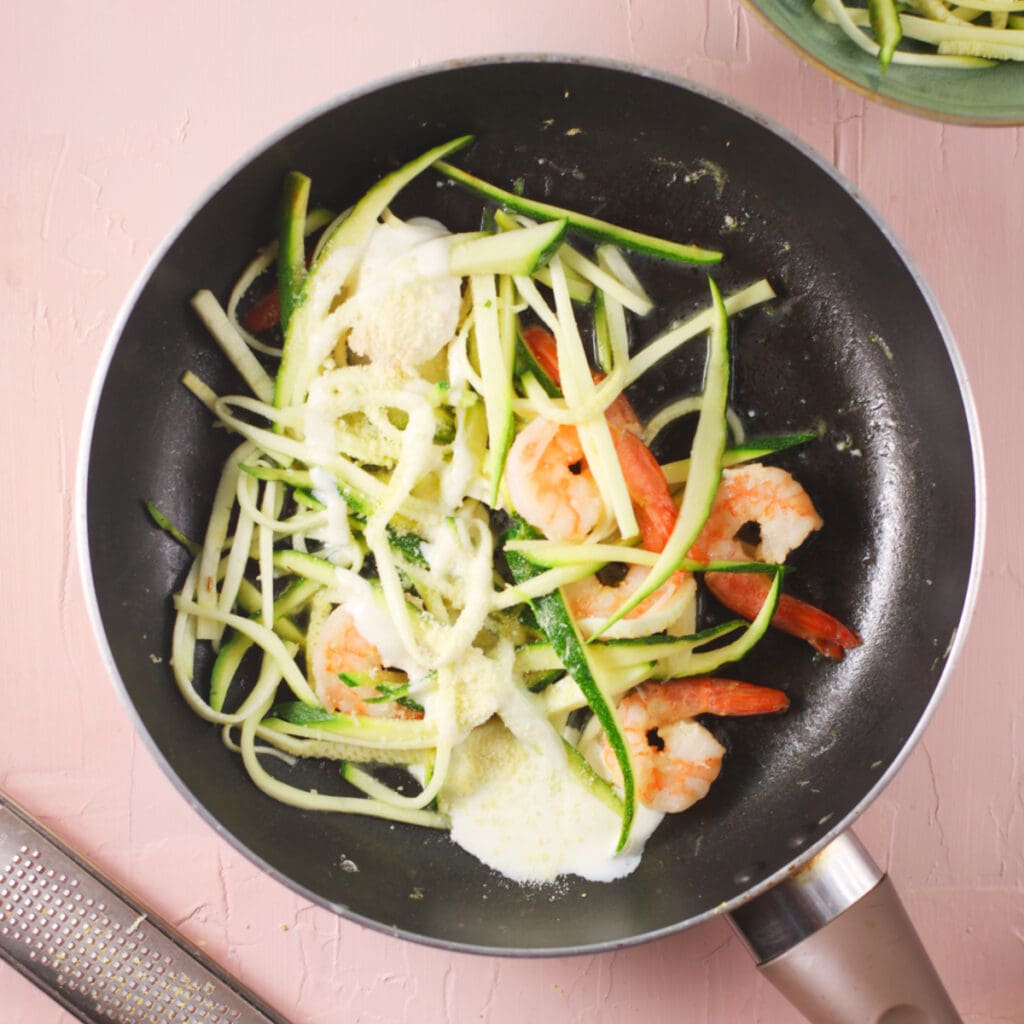 cooked shrimps and zucchini strips with sauce