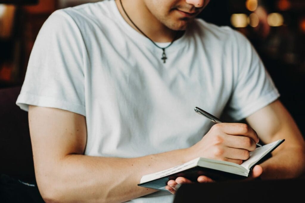 guy writing on his journal