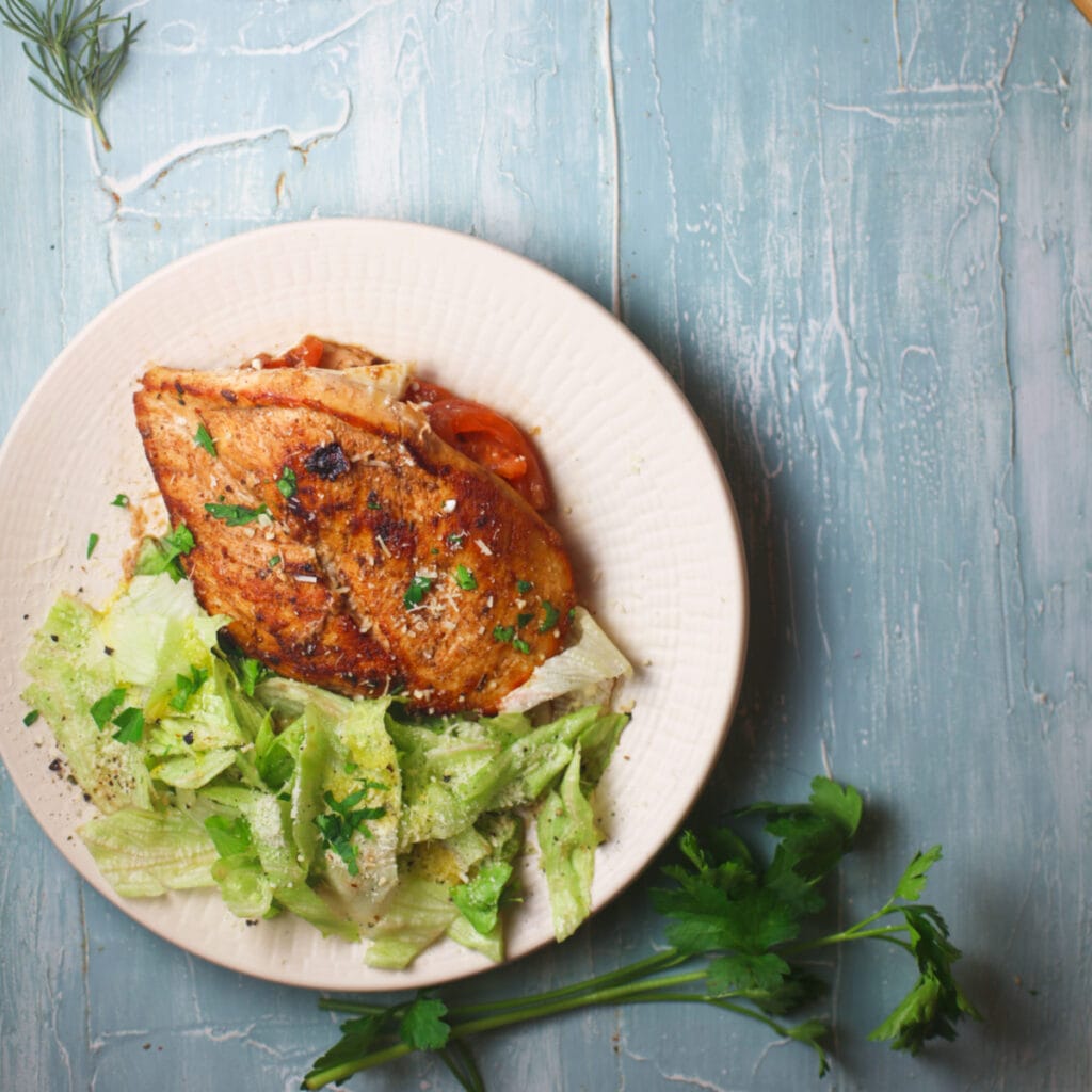 delicious pan fried stuffed chicken breast on a plate