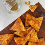 nacho cheese chips on a cutting board