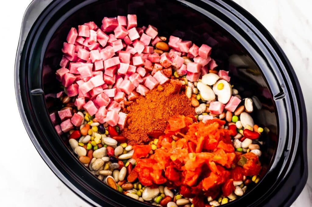 slow cooker pot with ham, beans, and seasonings