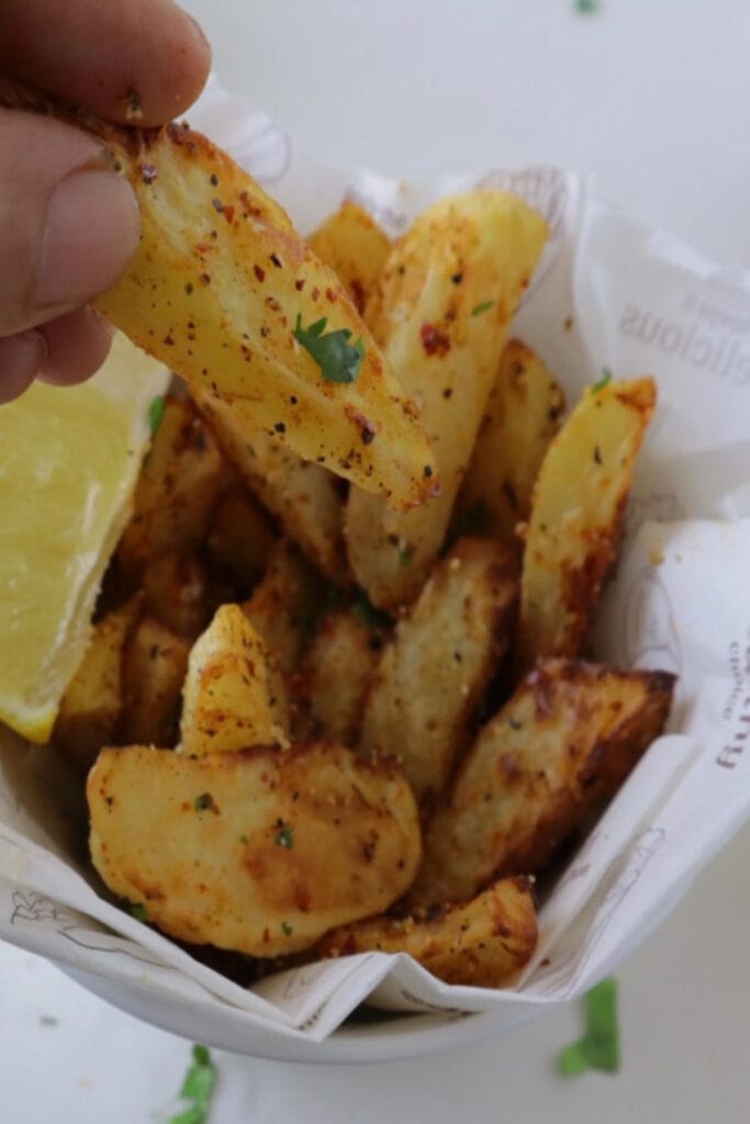 seasoned potato wedges on a container