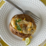 plate of baked potato with cheese and corn