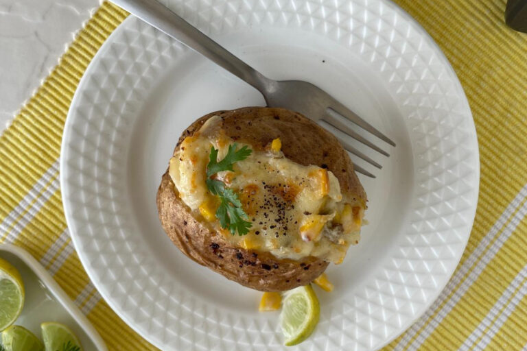 plate of baked potato with cheese and corn