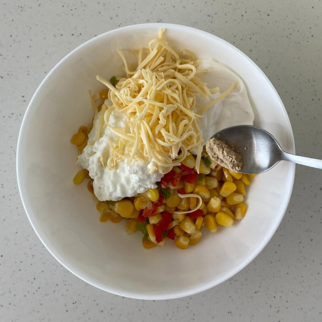 fiesta corn cheese and sour cream in a bowl
