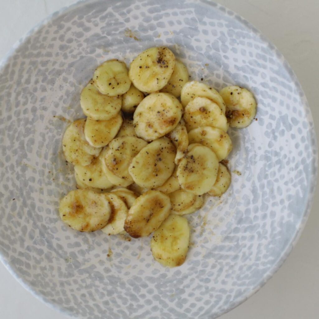bowl of sliced bananas with seasoning