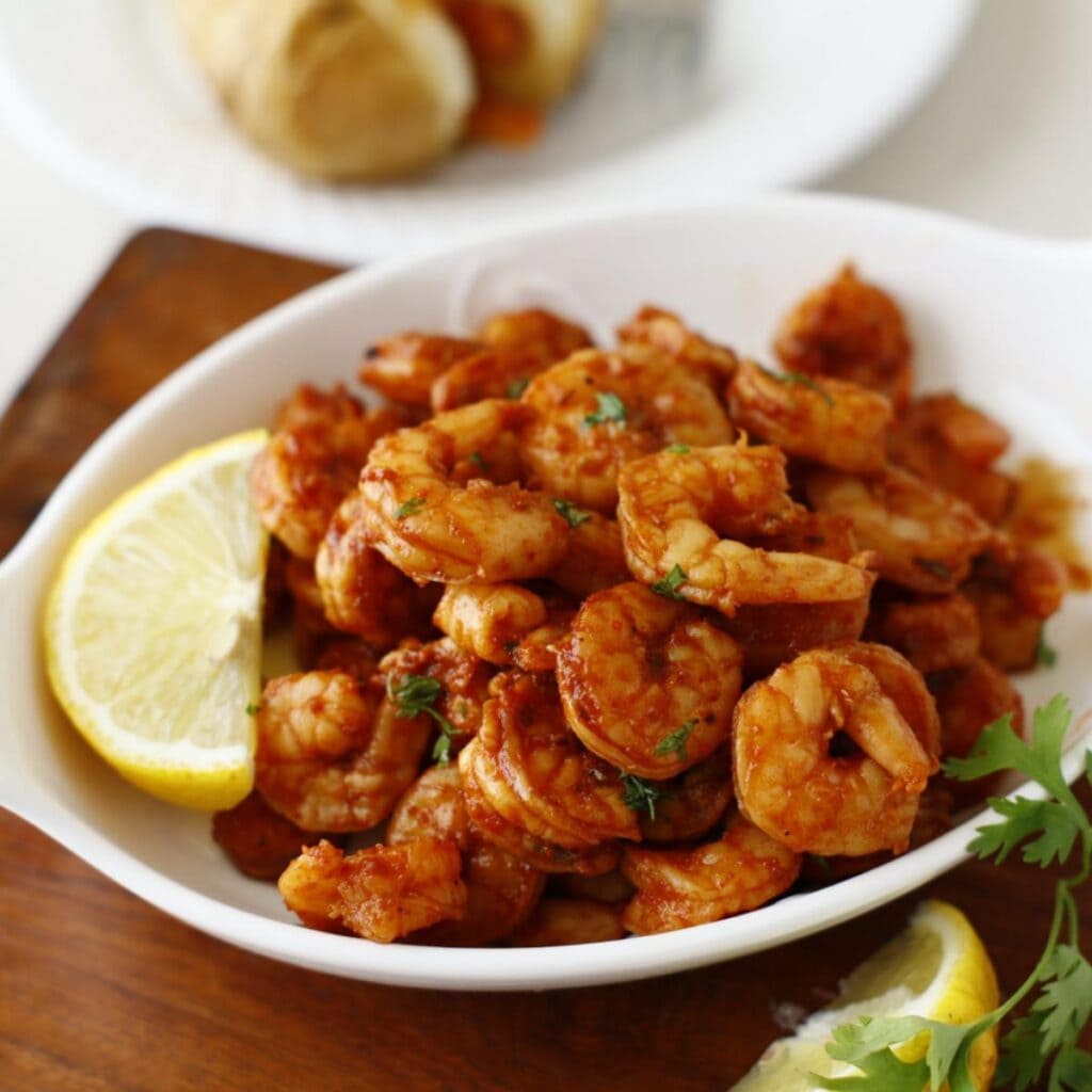 Seasoned shrimps on a serving plate garnish with cilantro