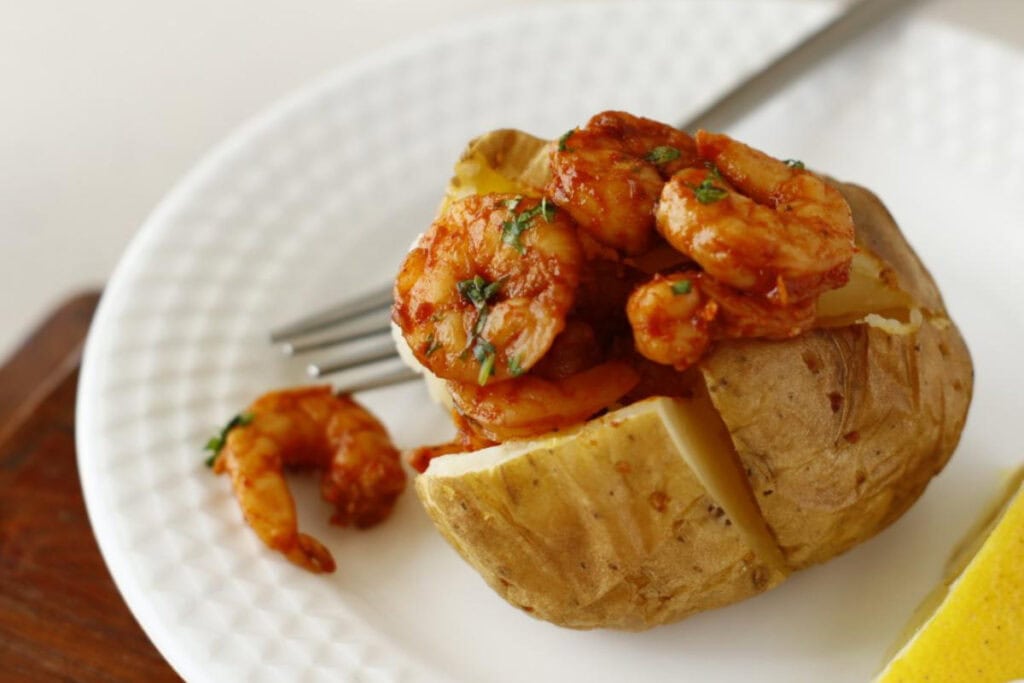 baked potato topped with seasoned shrimps