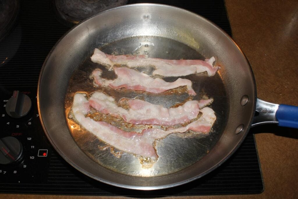Frying bacon on a pan