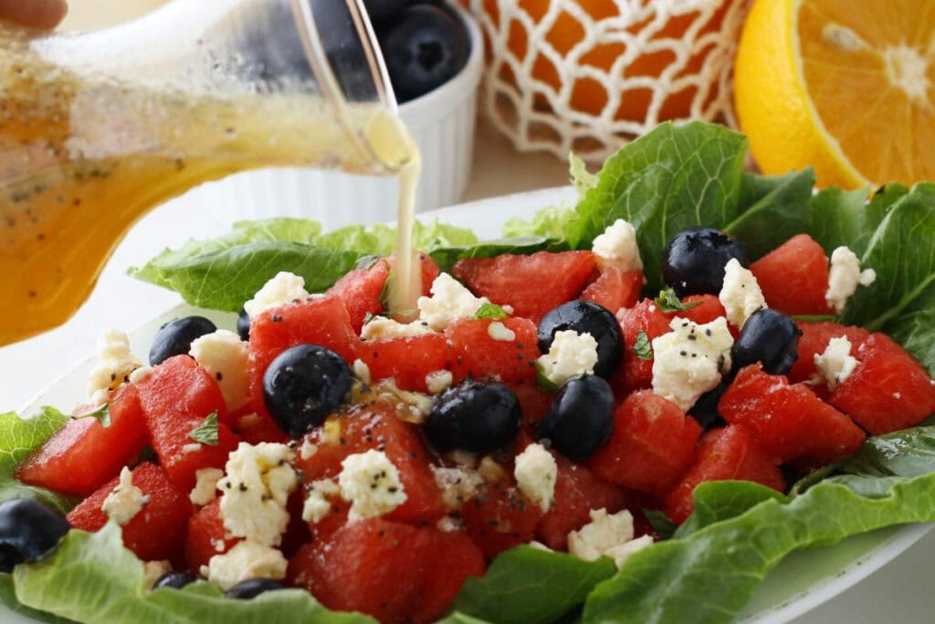 watermelon blueberry lettuce and feta salad with dressing