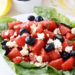 close up shot of salad with blueberries and cheese