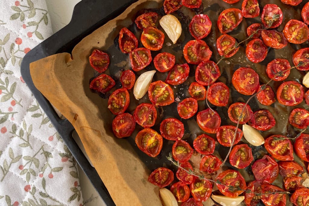 pan of grape tomatoes with thyme and garlic