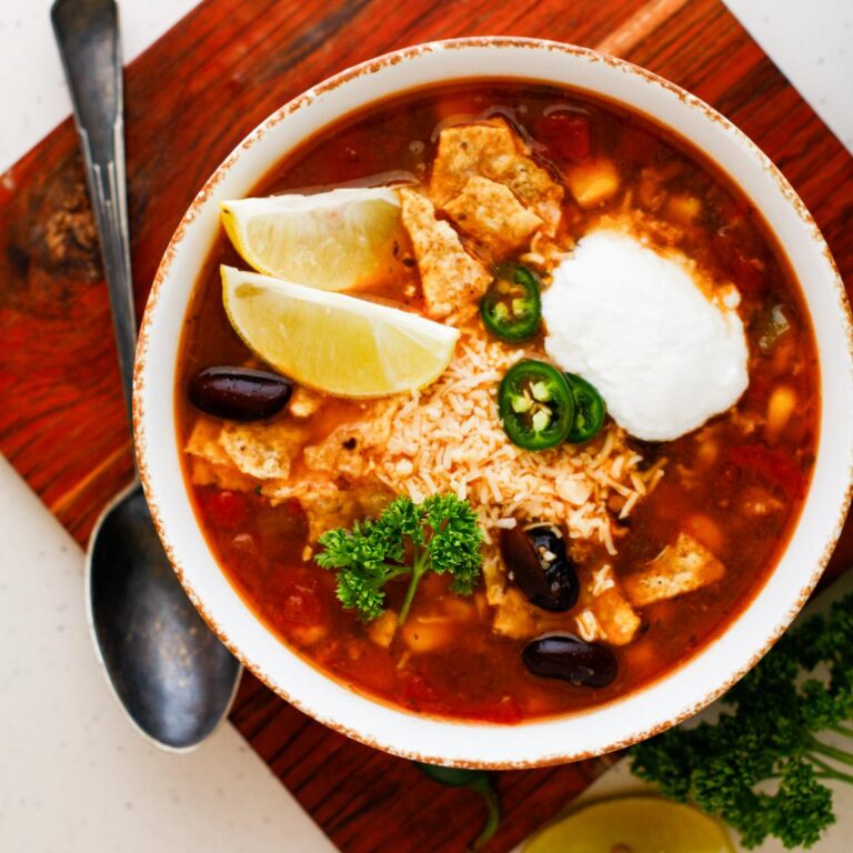 A delicious bowl of taco soup with lemon slices and garnish