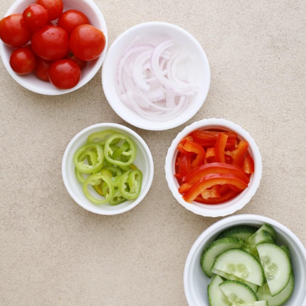bowls of sliced veggies
